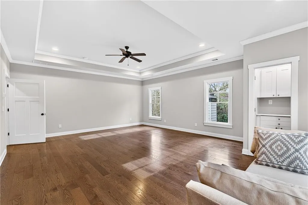 Spacious and bright primary bedroom on upper level with separate work space, ensuite spa-like bath and expansive walk-in closet