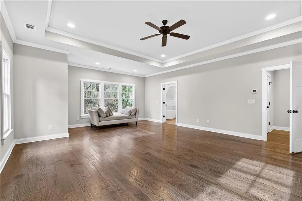 Spacious and bright primary bedroom on upper level with separate work space, ensuite spa-like bath and expansive walk-in closet
