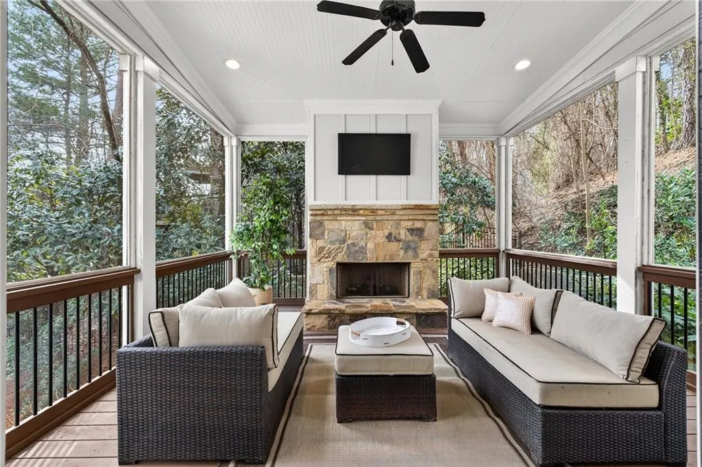 Screened in porch an outdoor living space with a fireplace, ceiling fan