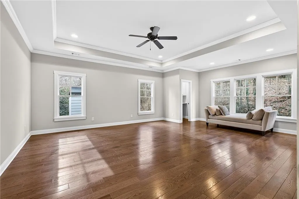 Spacious and bright primary bedroom on upper level with separate work space, ensuite spa-like bath and expansive walk-in closet