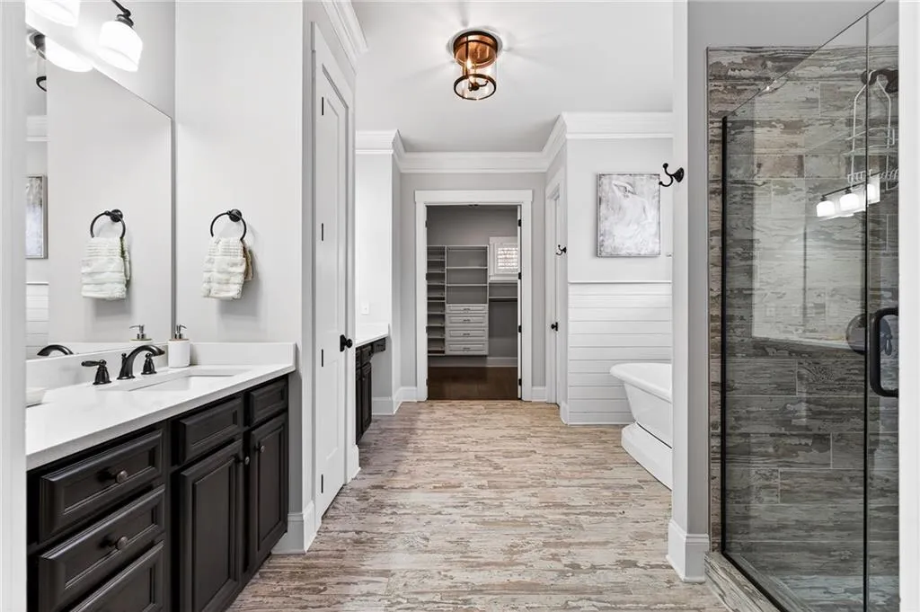 Main level ensuite bath with dual vanities, soaking tub and separate shower
