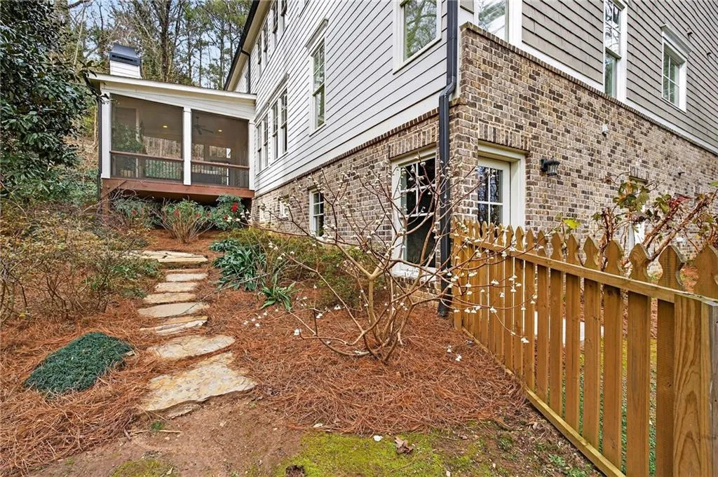 View of property exterior featuring brick and cement siding