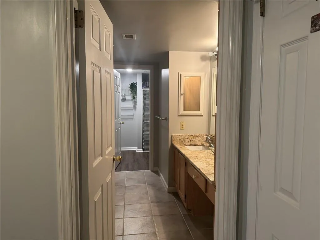 Bathroom featuring vanity and light tile patterned floors