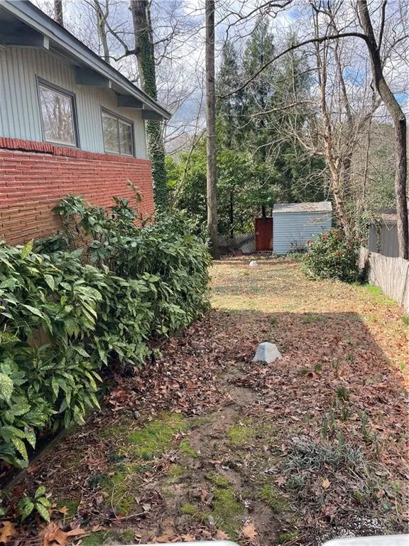 View of yard featuring a storage unit