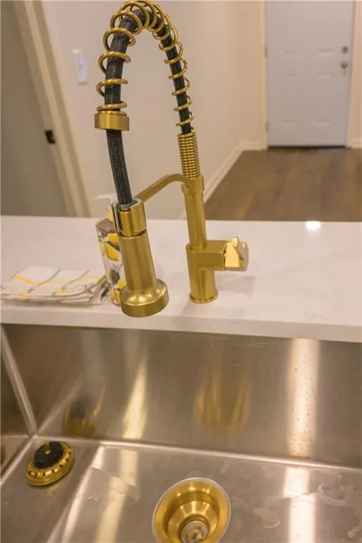 Kitchen view of a sink and baseboards
