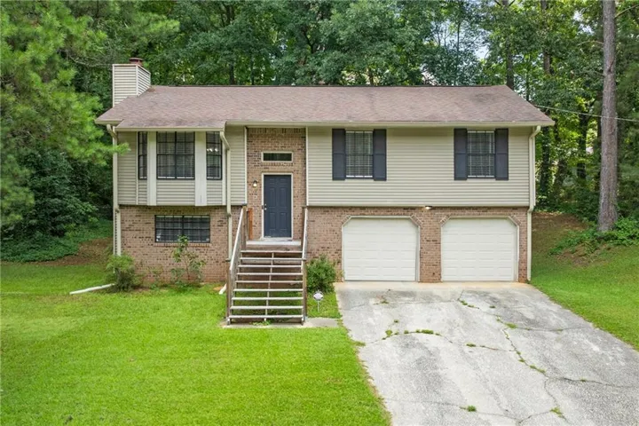 Split-level exterior featuring brick and siding accents