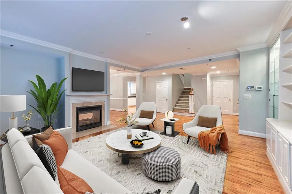 Living room with crown molding and hardwood floors