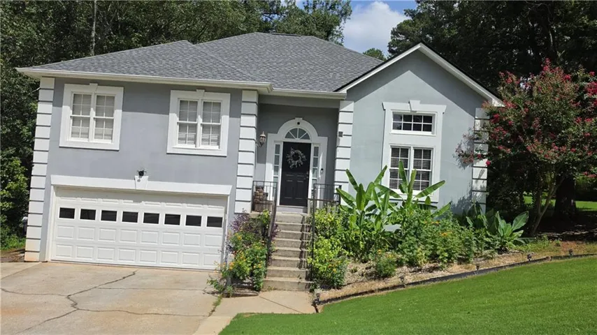 Stucco exterior with white trim accents and architectural details