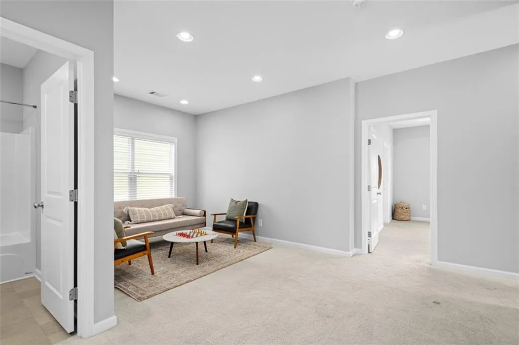 Living area featuring recessed lighting and light colored carpet