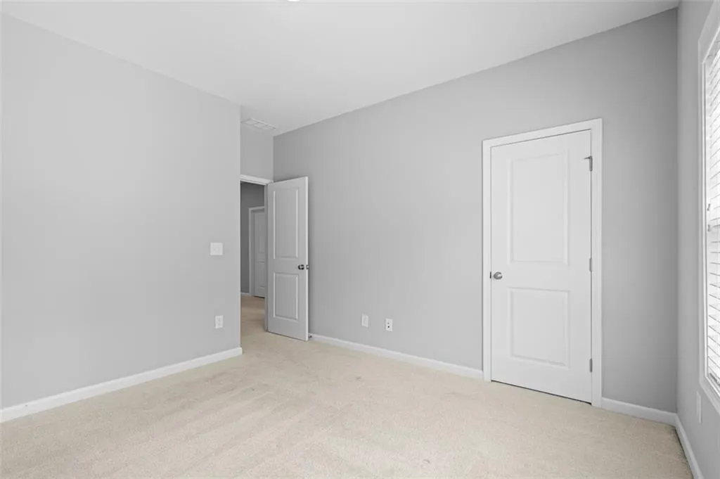 Unfurnished bedroom with carpet and baseboards