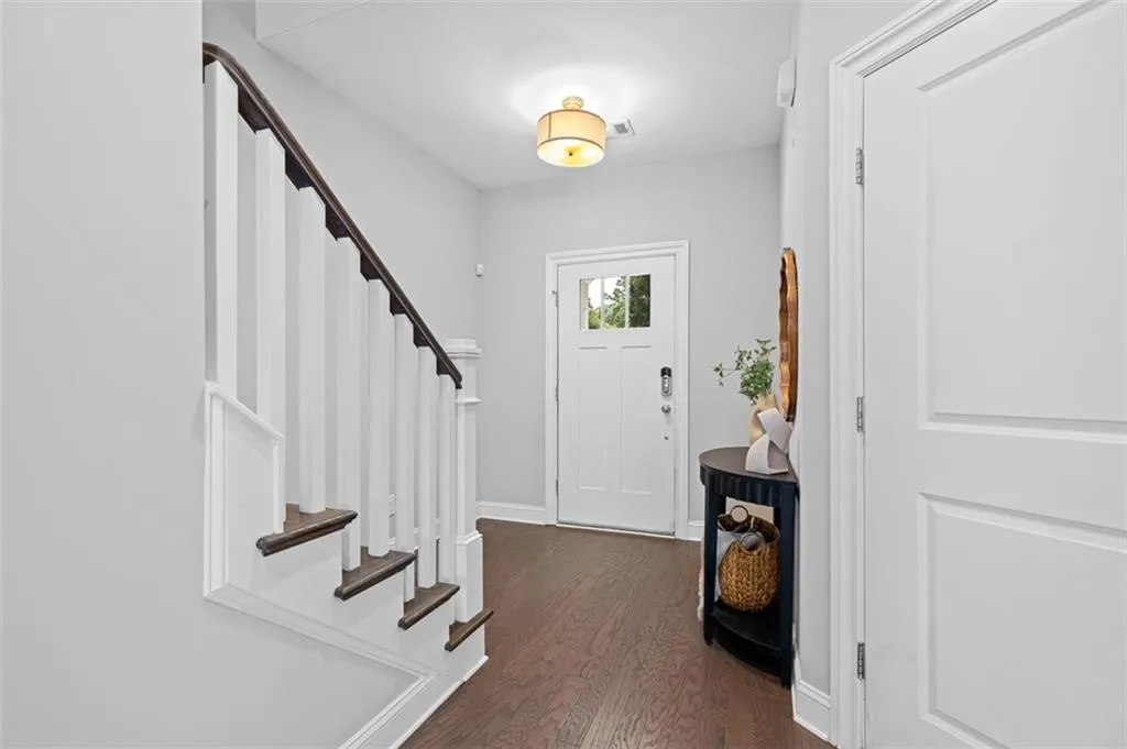 Entryway with stairway and dark wood-style flooring