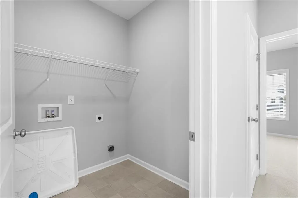 Washroom featuring electric dryer hookup and washer hookup