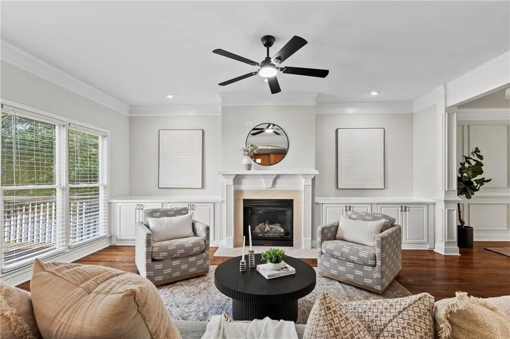 Living room with built in cabinets, new ceiling fan, and recessed lighting