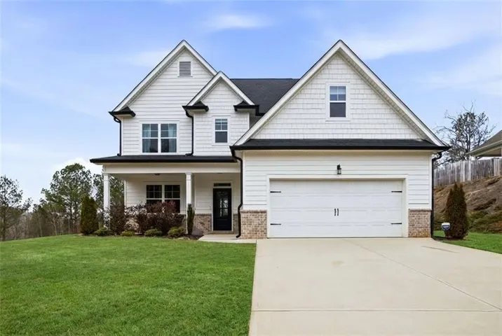 Front of home with nice large front yard and driveway