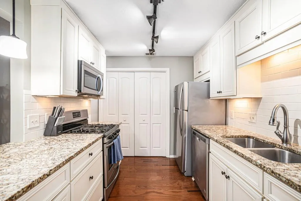 Spacious Kitchen With Stainless Steel Appliances, Granite Coutertops, & Subway Tile Backsplash