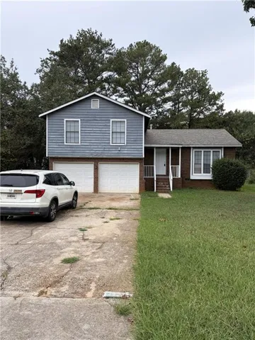 Brick lower level with siding upper level, double garage, and a front entry porch