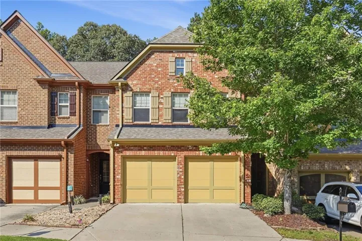 Brick exterior with a gabled roof and decorative shutters