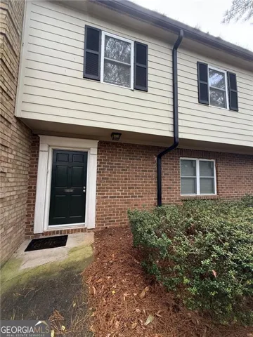 Brick and siding exterior with black functional shutters