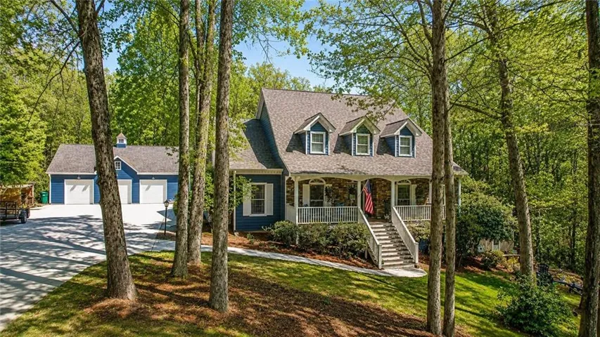 Blue siding residence with a stone accent facade and multiple dormer windows