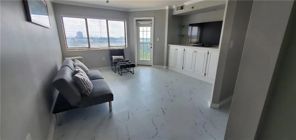 Living room featuring ornamental molding
