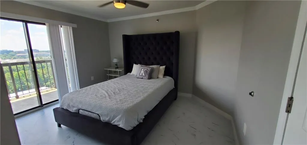 Bedroom featuring ceiling fan, crown molding, multiple windows, and access to outside