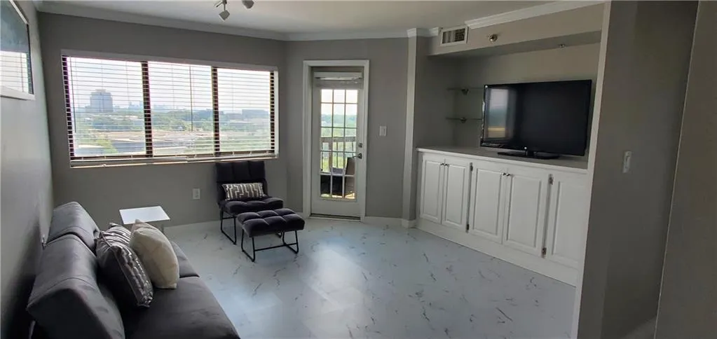 Living area featuring ornamental molding