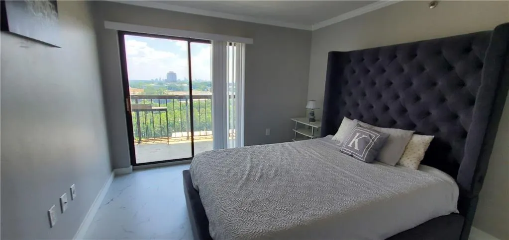 Bedroom featuring access to outside and ornamental molding