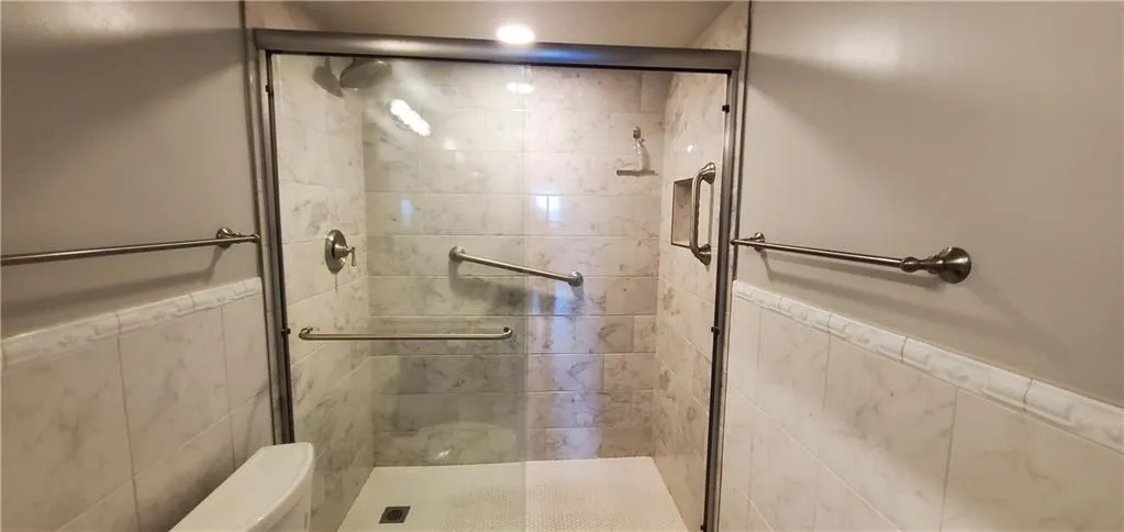 Bathroom with an enclosed shower and toilet