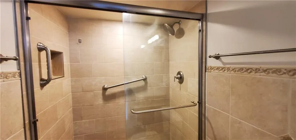 Bathroom with a shower with door