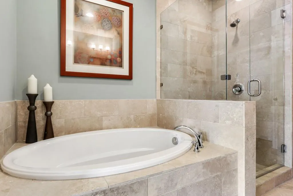 A closer look at the beautiful tile upgrades and seamless glass shower enclosure.