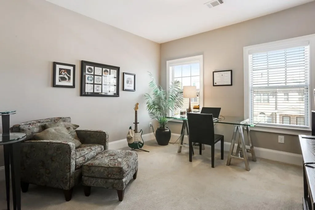 The spacious upstairs guest bedroom is currently being used as a home office. The bedroom also has a walk-in closet and ensuite bathroom.