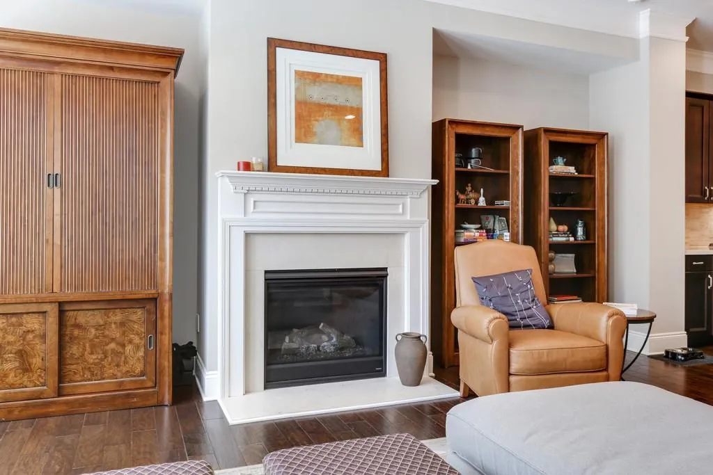 Upgraded fireplace surround in mocha creme marble with upgraded Truman mantle.