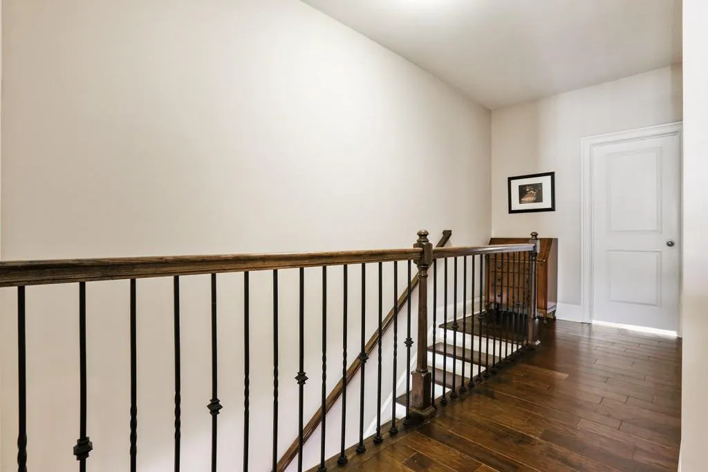 The iron pickets and the hardwood floors are upgrades in the upper hall.