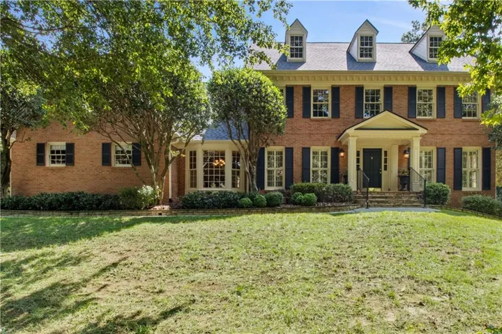 Brick exterior with black shutters
