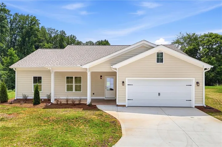 Ranch-style exterior with light beige siding and white trim