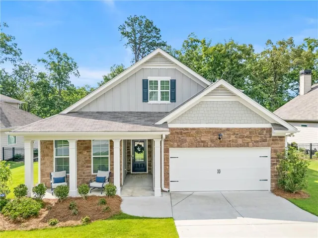 Charming single-story residence featuring a covered front porch with white columns