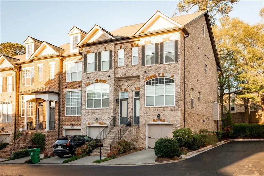 View of front of home featuring brick siding and an attached garage