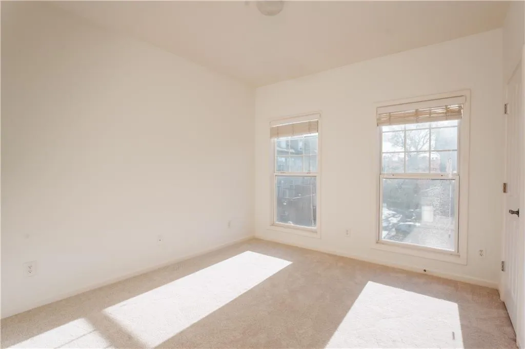Carpeted spare room with baseboards
