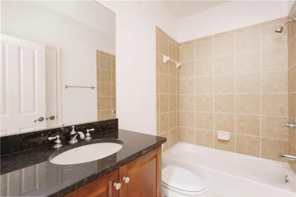 Bathroom featuring bathtub / shower combination and vanity