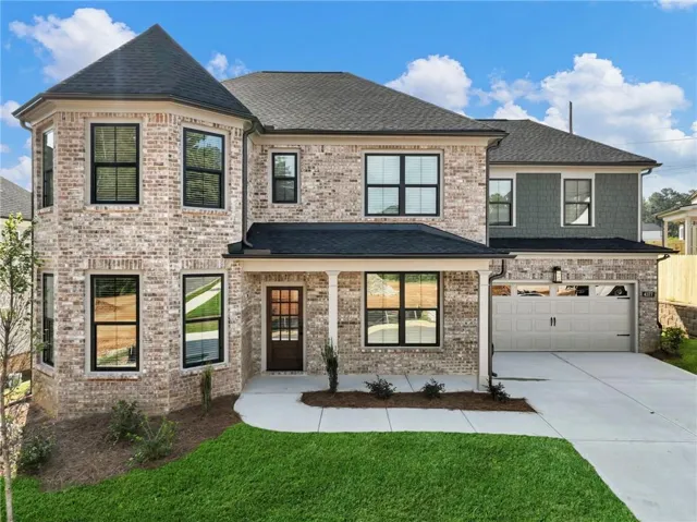 Brick exterior with a conical roof element, covered entry, and black-framed windows