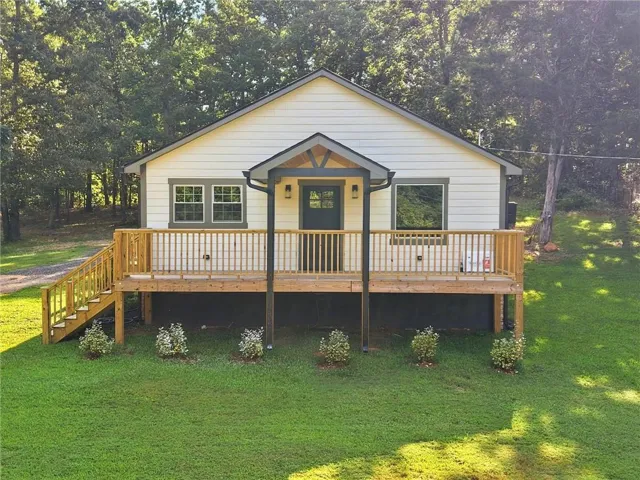 White siding exterior with dark trim accents