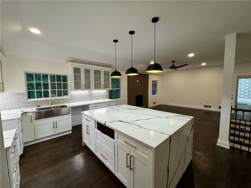 266 Colewood Way Kitchen with white cabinetry, backsplash, a center island, dark wood-type flooring, and sink