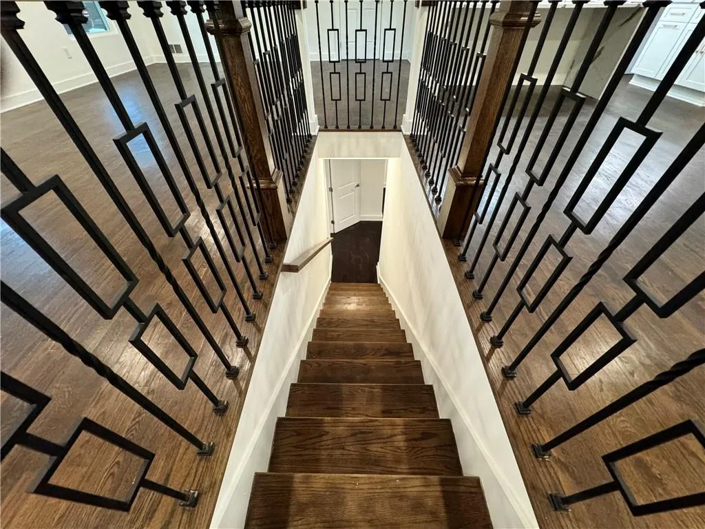 Staircase with dark wood-type flooring