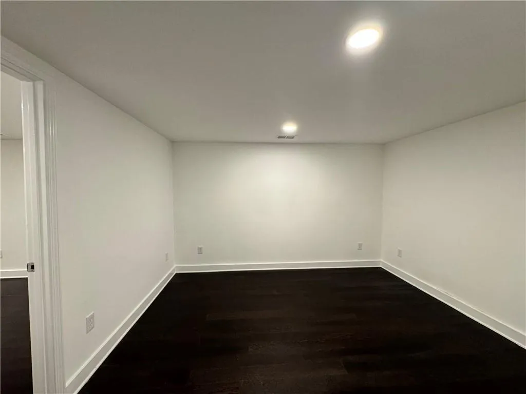 Basement featuring wood-type flooring