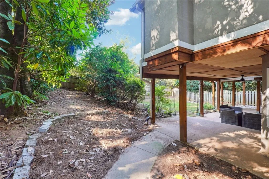 View from the gated entrance and pathway into the private backyard with a great secondary entertaining space that is covered by the sunroom upstairs (great for rainy days)
