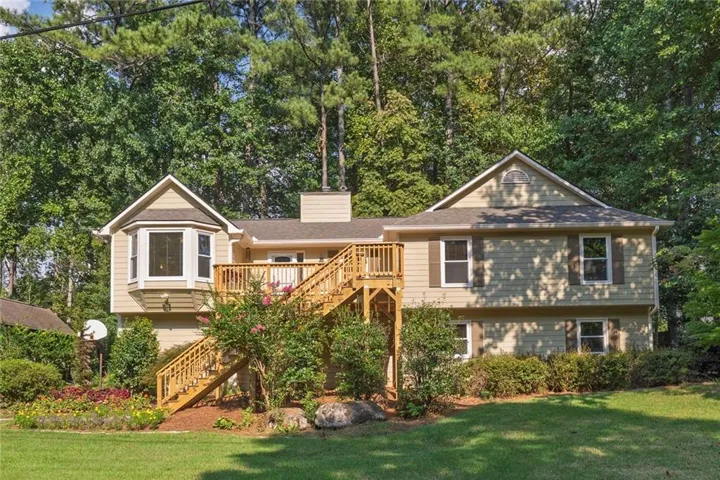 Welcome to 2363 Wilderness Way, a charming ranch-style home nestled in a beautifully landscaped setting with mature trees and a welcoming front entry.