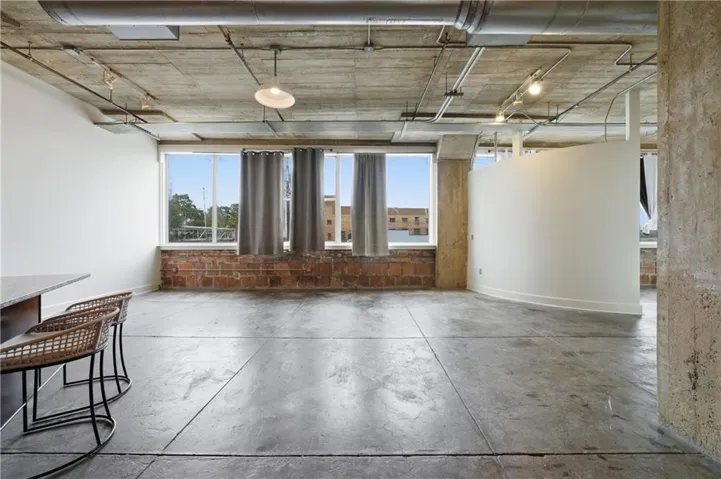 Spare room featuring concrete flooring and baseboards