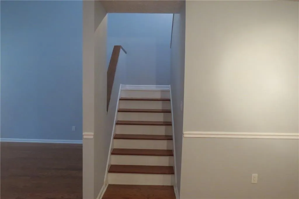 Staircase with hardwood / wood-style flooring