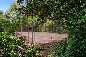 View of home's community tennis court