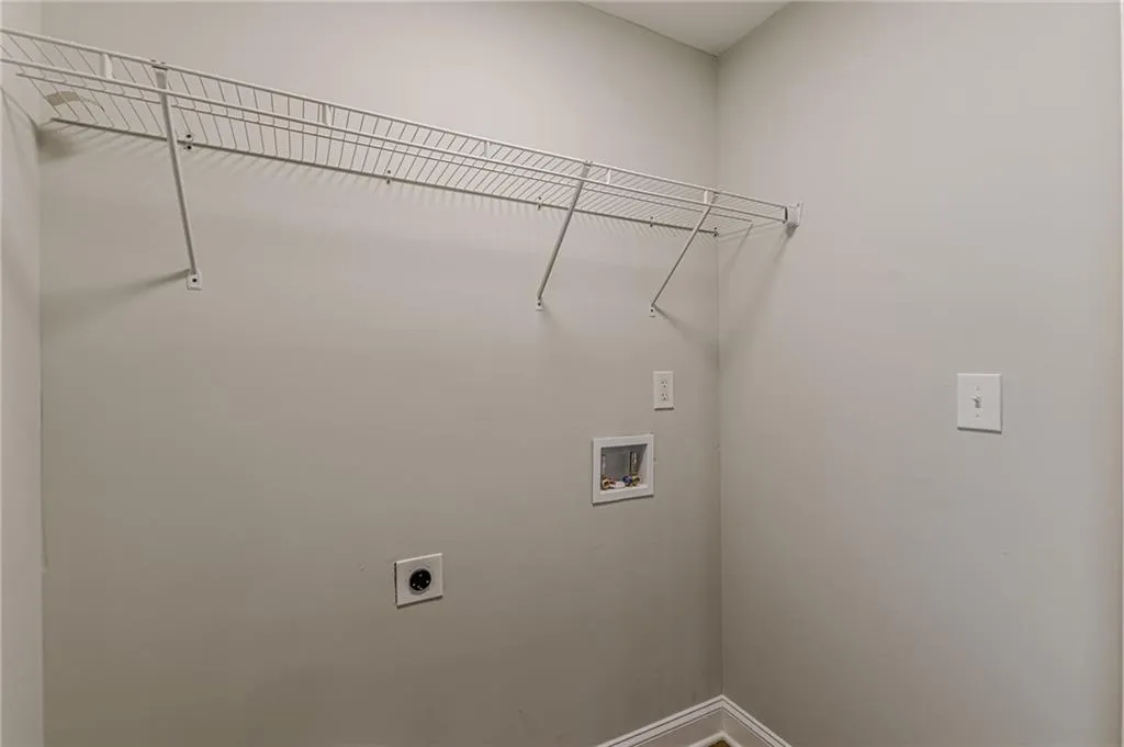 Washroom featuring hookup for an electric dryer and hookup for a washing machine